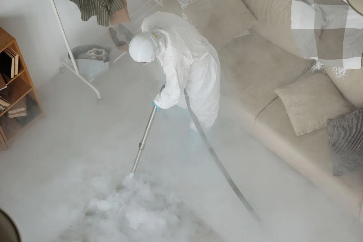 Biohazard cleanup technician in protective equipment, Fordyce, AR